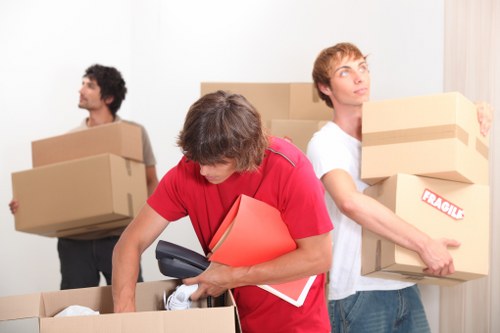 Removal team preparing furniture and boxes for transport in Bermondsey