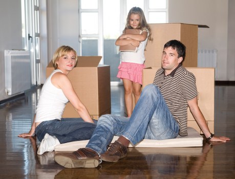 Team using protective gear and blankets while moving household items